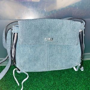 Light wash denim purse with separate zipper compartment.